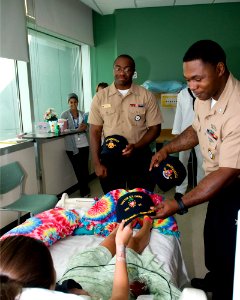US Navy 100811-N-2389S-063 Culinary Specialist 2nd Class John Davis gives a Navy ball cap to a patient in the children's hospital as part of Caps for Kids during Chicago Navy Week