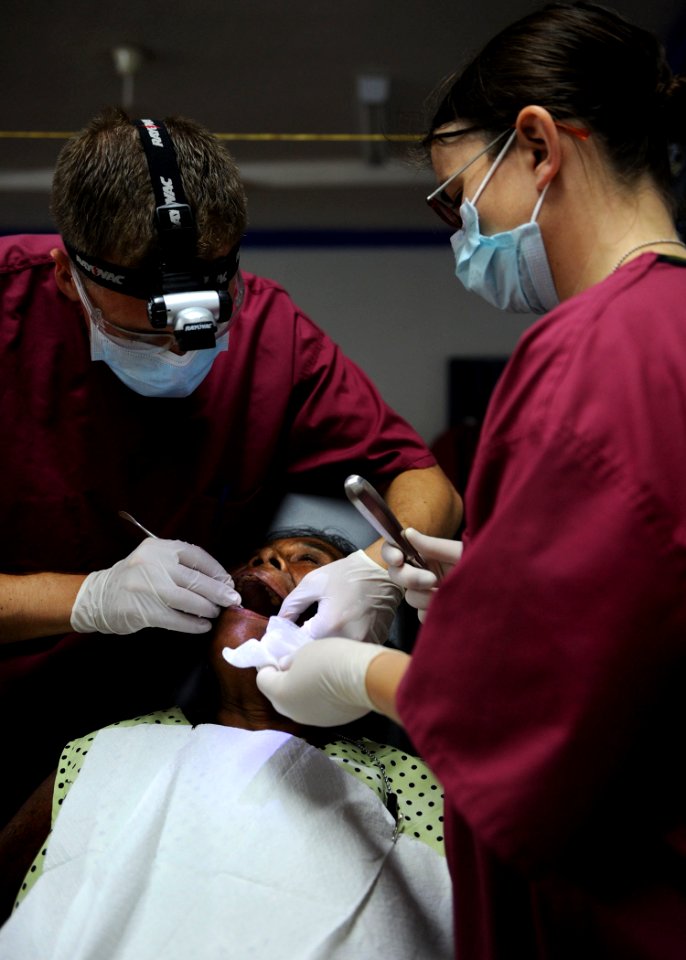 US Navy 100811-N-4153W-270 Capt. Davin Schmidt and Cpl. Angela Smid extract teeth from a Colombian woman at Escuela Ismael Contreras, in Covena, Colombia