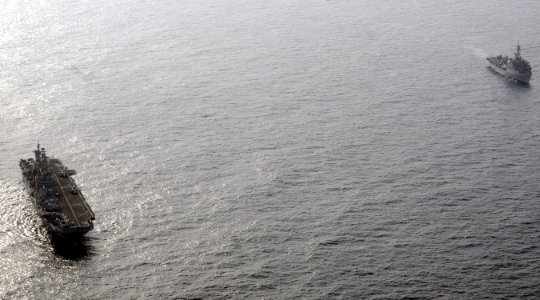 US Navy 100813-N-3729D-012 The amphibious assault ship USS Peleliu (LHA 5), left, and the amphibious transport dock ship USS Dubuque (LPD 8) are underway off the coast of Pakistan
