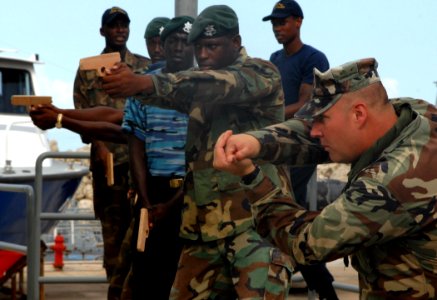 US Navy 100811-N-4971L-143 Chief Boatswain's Mate Tim Shepke demonstrates proper close combat techniques for Barbados Defense Forces during a subject matter expert exchange in Bridgetown, Barbados photo