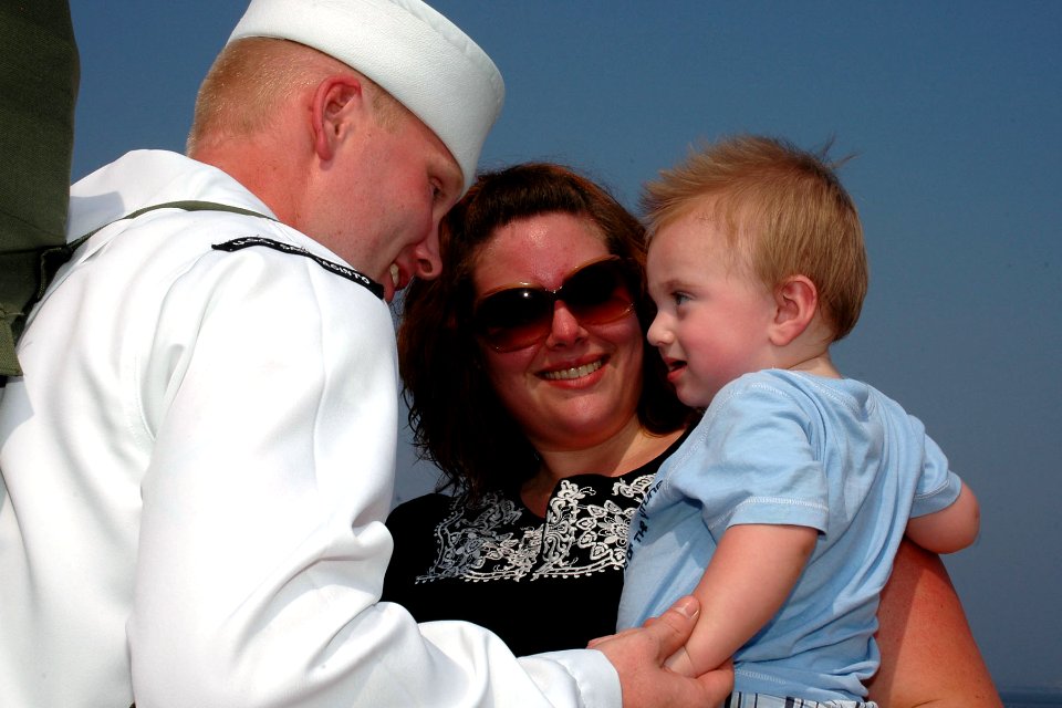 US Navy 100811-N-5292M-511 Electrician's Mate 2nd Class Chris Everheart greets his wife and one-year-old son during a homecoming celebration for the guided-missile cruiser USS San Jacinto (CG 56)