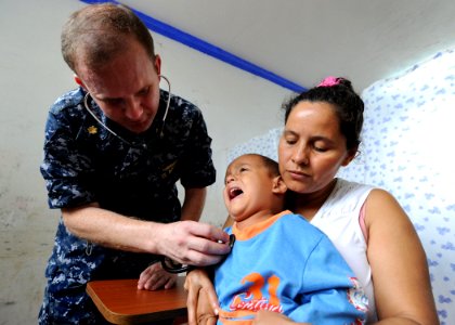 US Navy 100811-N-4153W-184 Lt. Cmdr. Brian Thomas checks the heart beat of a Colombian child at Escuela Ismael Contreras, in Covenas, Colombia