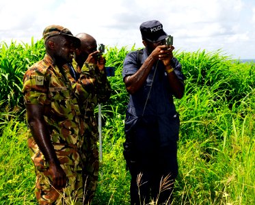 US Navy 100811-N-9643W-449 Members of the Barbados Defense Force search for pre-placed points during the land navigation portion of the Marine Corps subject matter expert exchange photo