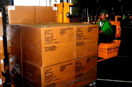 US Navy 100814-N-4378P-043 Logistics Specialist 3rd Class Juan Reyes loads a pallet of supplies aboard USS Peleliu (LHA 5)