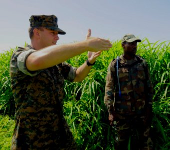 US Navy 100811-N-9643W-361 Marine Corps Gunnery Sgt. Chad Fordyce gives direction to a member of the Barbados Defense Force looking for pre-placed points during the land navigation portion of the Marine Corps subject matter exp photo