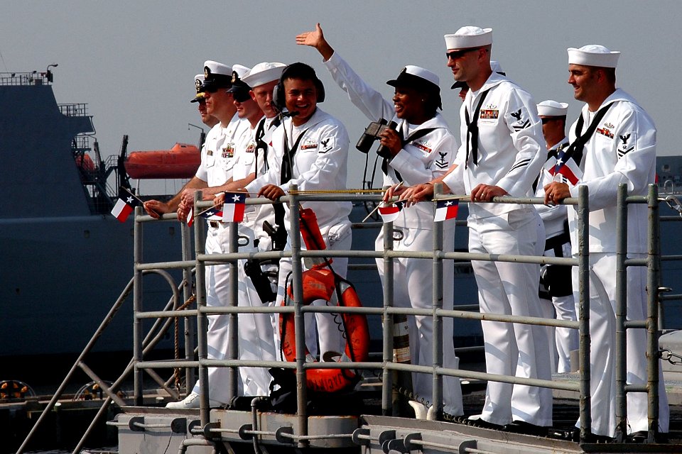 US Navy 100811-N-5292M-454 Sailors aboard the guided-missile cruiser USS San Jacinto (CG 56) wave to family and friends as the ship arrives at Naval Station Norfolk after a seven-month deployment to the U.S. 5th and 6th Fleet a