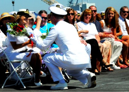 US Navy 100812-N-1004S-250 The wife of Capt. Kenneth J. Norton receives flowers during a change of command ceremony for her support during his tour as commanding officer of USS Ronald Reagan (CVN 76)