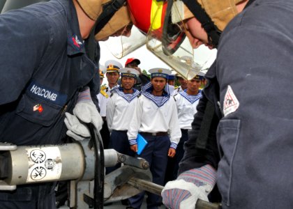 US Navy 100812-N-3215T-238 Vietnam People's Navy sailors watch as Sailors assigned to the guided-missile destroyer USS John S. McCain (DDG 56) demonstrate how to use a hydrolic cutting device during a damage control demonstrati