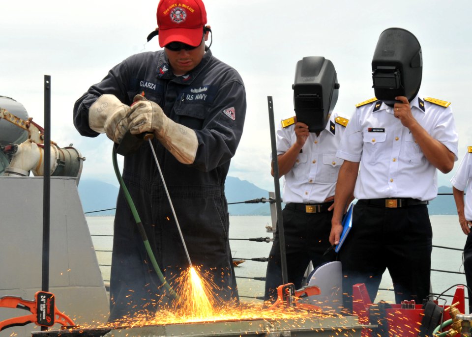 US Navy 100812-N-3215T-193 Damage Controlman 2nd Class Steven Galarza demonstrates how to use a portable exothermal cutting unit