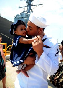 US Navy 100815-N-8936G-067 Quartermaster Seaman Bryant Dawson greets his daughter for the first time after returning from a seven-month deployment aboard the amphibious assault ship USS Nassau (LHA 4)