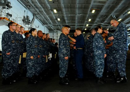 US Navy 100815-N-1092P-061 Sailors receive their Enlisted Air Warfare Specialist and Enlisted Surface Warfare Specialist pins during a pinning ceremony aboard the aircraft carrier USS Harry S. Truman (CVN 75)