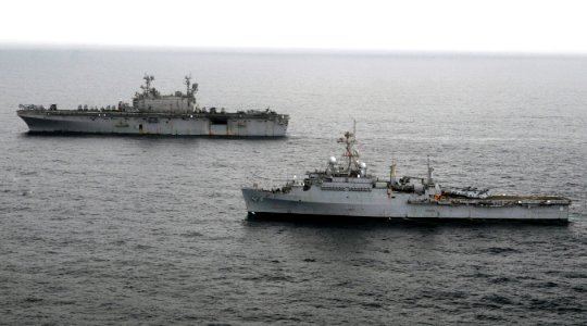 US Navy 100813-N-3729D-027 The amphibious assault ship USS Peleliu (LHA 5), left, and the amphibious transport dock ship USS Dubuque (LPD 8) are underway off the coast of Pakistan