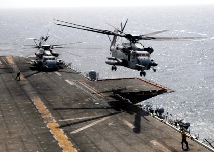 US Navy 100812-N-3729D-026 Marine Corps CH-53E Sea Stallion helicopters assigned to the White Knights of Helicopter Marine Medium Squadron (HMM) 165 lift off from the amphibious assault ship USS Peleliu (LHA 5)