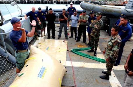 US Navy 100813-N-9769P-048 Navy Diver 1st Class Chris Whitman explains the capabilities of the 4,000-lb. lift bag to Panamanian and Peruvian divers