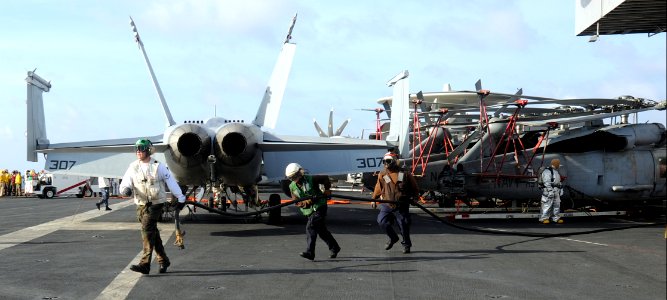 US Navy 100813-N-1287L-027 Sailors fake out a hose in preparation to fight a simulated fire on the flight deck of USS Enterprise (CVN 65)