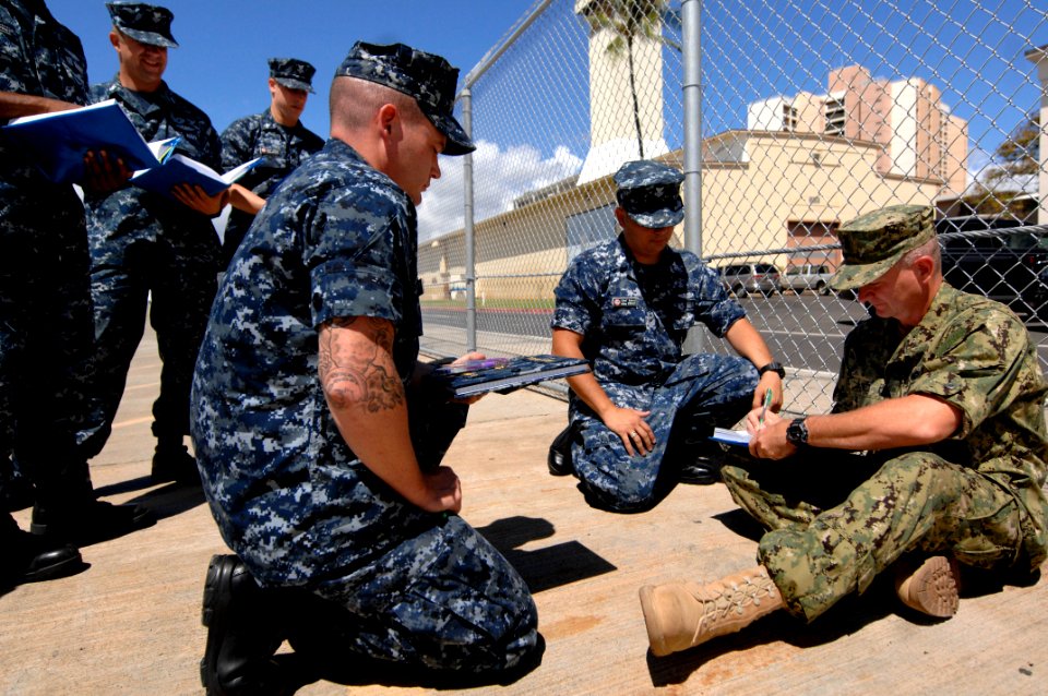 US Navy 100816-N-9818V-458 Master Chief Petty Officer of the Navy (MCPON) Rick West signs the charge books of chief petty officer selectees from USS La Jolla (SSN 701) and USS Pasadena (SSN 752)