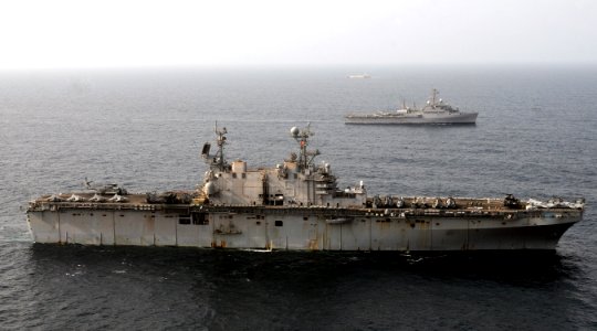 US Navy 100813-N-3729D-023 The amphibious assault ship USS Peleliu (LHA 5), left, and the amphibious transport dock ship USS Dubuque (LPD 8) are underway off the coast of Pakistan