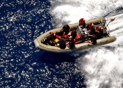 US Navy 100817-N-4649B-024 Sailors assigned to the multipurpose amphibious assault ship USS Bataan (LHD 5) conduct a rigid-hull inflatable boat recovery during a man overboard drill