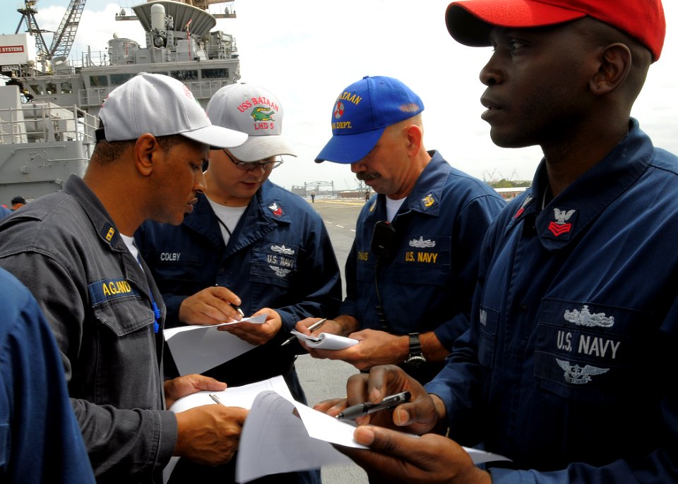 US Navy 100813-N-4649B-021 Sailors aboard the multipurpose amphibious assault ship USS Bataan (LHD 5) discuss life raft assignments during an abandon ship drill