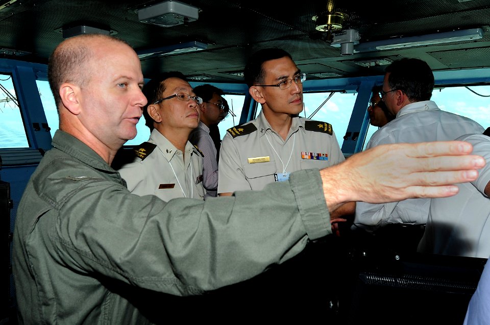 US Navy 100817-N-7191M-019 Capt. Ross A. Myers, left, commander of Carrier Air Wing (CVW) 5, explains flight operations to Singapore Army Brig. Gen. David Koh and Brig. Gen. Benjamin Seet during their visit to the aircraft carr
