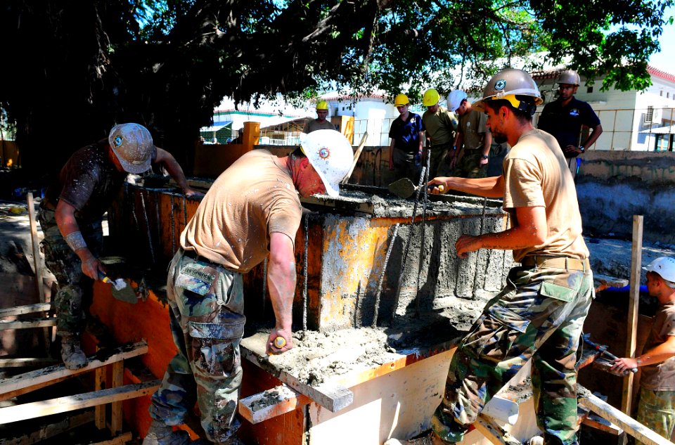 US Navy 100817-N-6410J-066 Seabees assigned to Naval Mobile Construction Battalion (NMCB) 11, and Australian Defense Force engineers apply cement to a renovated section of Nu Laran School
