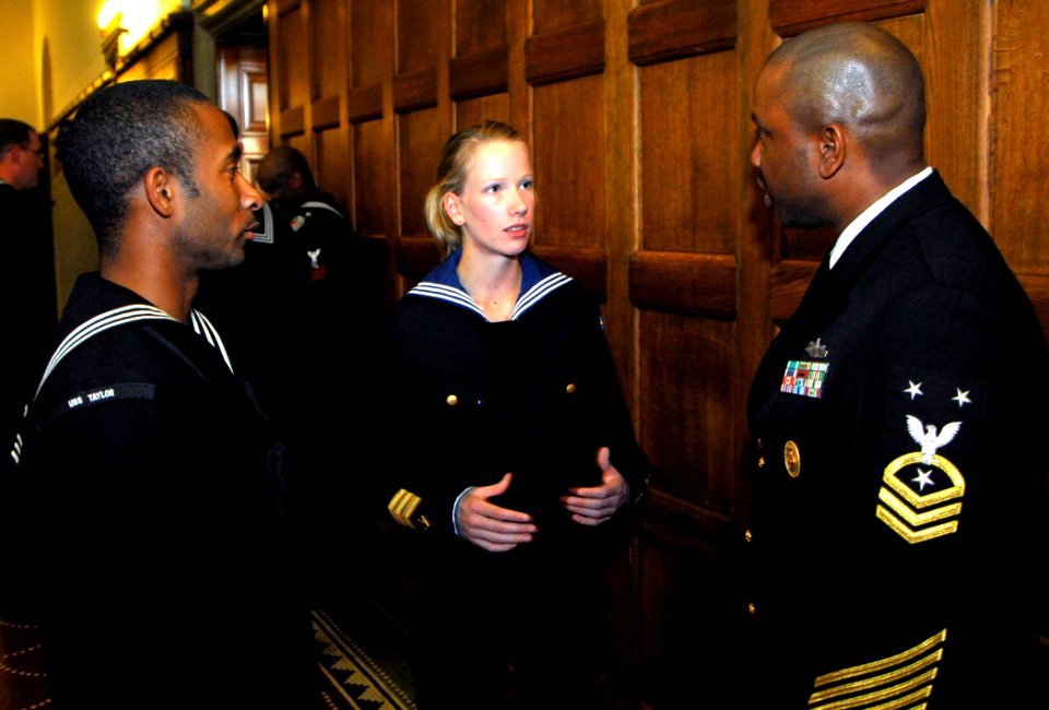 US Navy 100813-N-7638K-228 ommand Master Chief Steven Allen, right, and Quartermaster Seaman Josh Mobley, left, discuss the similarities and differences of their navies with a Swedish navy sailor during a reception hosted by th