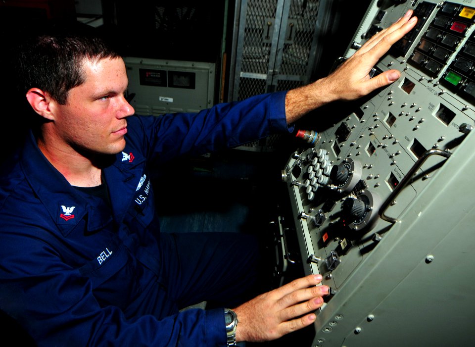 US Navy 100817-N-7948R-199 Fire Controlman 2nd Class Geoffrey Bell uses a local control panel to place a close-in weapons system (CIWS) in aim calibrate mode during a calibration firing exercise