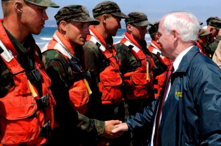US Navy 100813-N-7883G-125 Secretary of Defense Robert M. Gates congratulates a candidate from Basic Underwater Demolition-Sea, Air and Land (BUD-S) class 284 after securing him and his peers from Hell Week