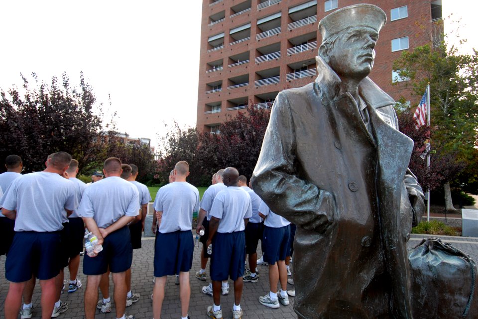 US Navy 100816-N-6676S-023 Chief petty officer (CPO) selectees listen to a tour guide explain the history of The Lone Sailor statue