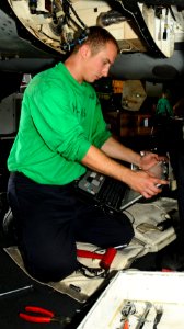 US Navy 100818-N-1092P-087 Aviation Machinist's Mate 3rd Class Kazimierz Rojek searches through Interactive Electronic Technical Manuals during maintenance on an F-A-18E Super Hornet engine aboard USS Harry S. Truman (CVN 75)