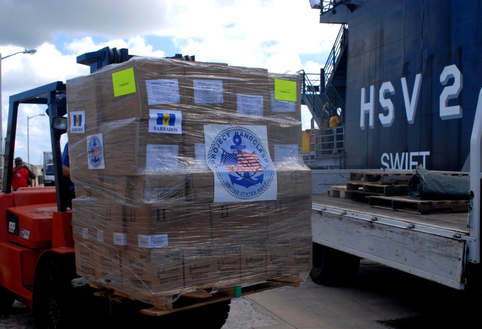 US Navy 100813-N-4971L-075 High Speed Vessel Swift (HSV 2) crew members load a pallet of school supplies from the ship onto a truck for delivery in Bridgetown, Barbados