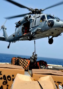 US Navy 100814-N-1226D-399 Marines hook up a cargo net to an MH-60S Sea Hawk helicopter aboard USS Peleliu (LHA 5)