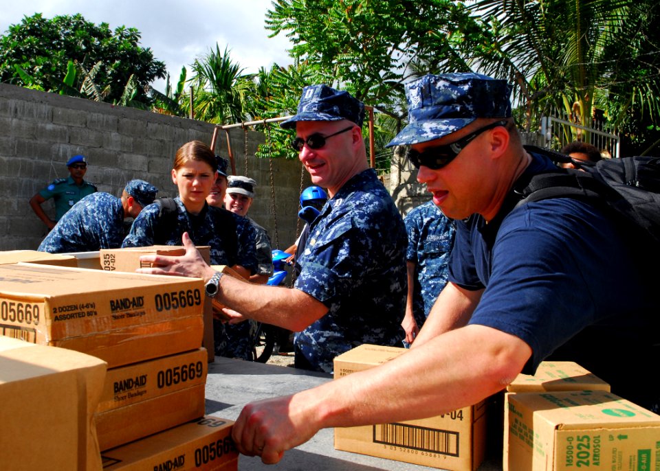 US Navy 100818-N-4044H-034 Sailors assigned to the Military Sealift Command hospital ship USNS Mercy (T-AH 19) offload donated medical supplies at a community service event at the Santa Bakhita Orphanage