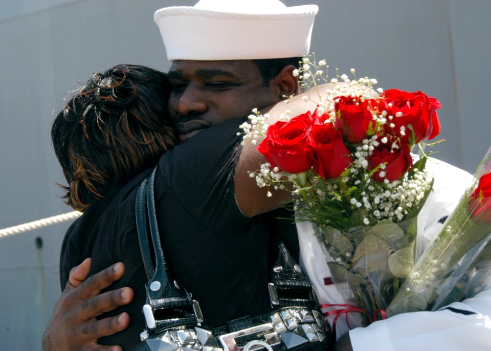 US Navy 100815-N-6764G-190 Engineman 2nd Class Mitchell Roberts embraces his wife after returning to Naval Station Norfolk