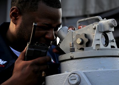 US Navy 100816-N-4649B-018 Quartermaster 2nd Class Troy Williams Jr., from Aliceville, Pa., takes the bearing of the pier with a gyro compass