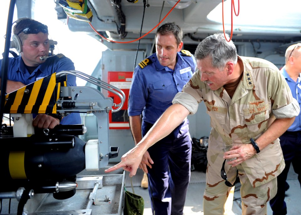 US Navy 100818-N-8959T-177 Vice Adm. Mark Fox, right, discusses the capabilities and operation of the mine neutralizer vehicle, Sea Fox, with Lt. Cmdr. Adam Northover