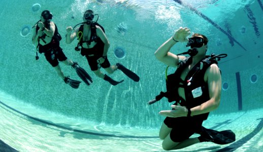 US Navy 100817-N-9769P-015 Navy Diver 2nd Class David Orme signals to Colombian divers during a Navy Diver-Southern Partnership Station underwater gear familiarization photo