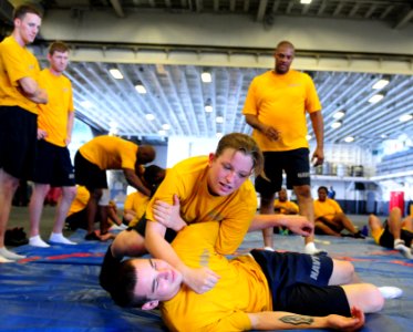 US Navy 100819-N-3852A-406 Operations Specialist Seaman Carol Chalut practices takedown defense moves with Gunner's Mate 3rd Class William Marler during Security Reaction Force Basic training