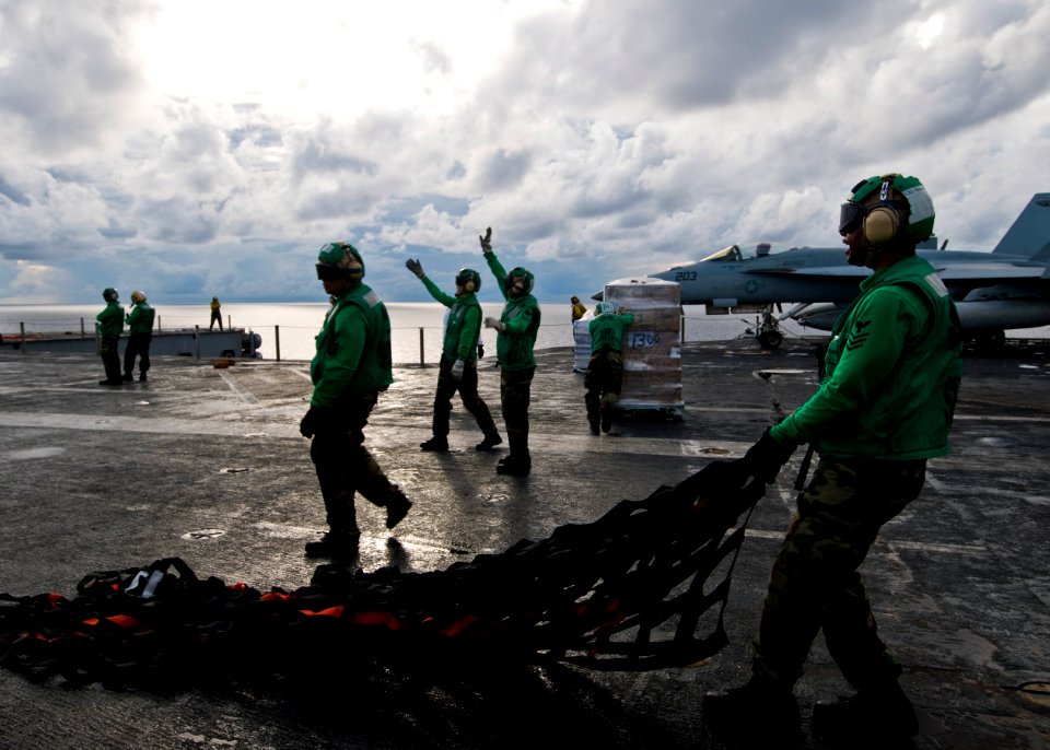 US Navy 100819-N-4830B-021 Sailors from the supply department aboard the aircraft carrier USS George Washington (CVN 73) move cargo nets during a vertical replenishment