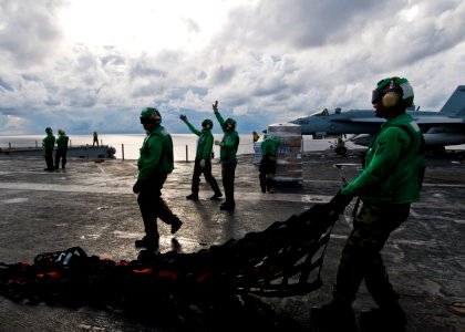 US Navy 100819-N-4830B-021 Sailors from the supply department aboard the aircraft carrier USS George Washington (CVN 73) move cargo nets during a vertical replenishment