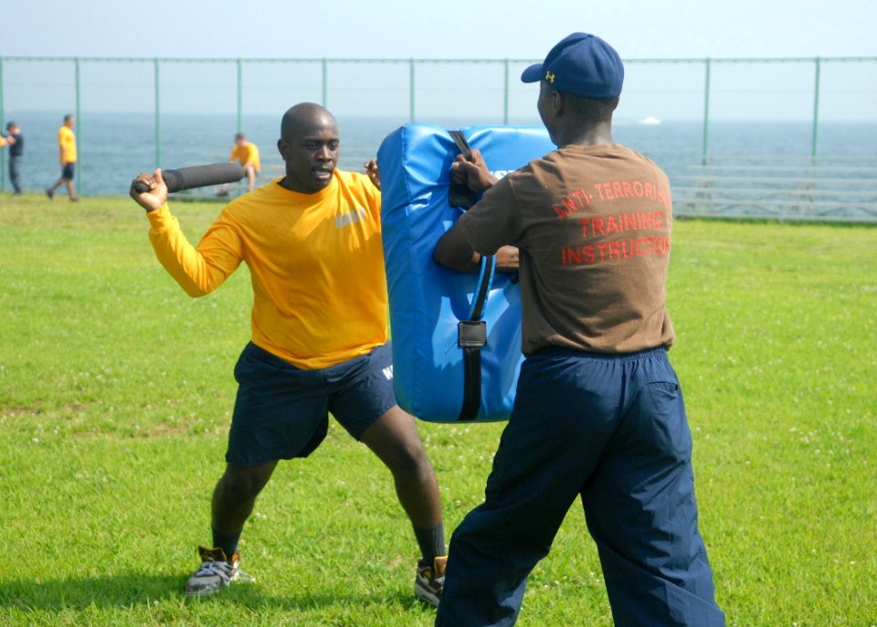 US Navy 100817-N-2218S-048 Master-at-Arms Seaman Aaron Bandele uses non-lethal techniques to subdue a simulated assailant after being sprayed with oleoresin capsicum (OC) spray