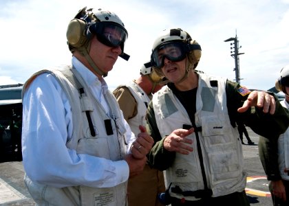 US Navy 100817-N-4830B-098 Capt. Daniel Grieco, right, executive officer of the aircraft carrier USS George Washington (CVN 73), explains carrier flight deck operations to U.S. ambassador to Singapore David Adelman
