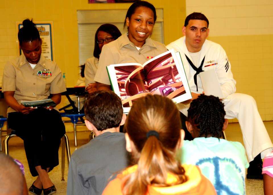 US Navy 100817-N-7908T-176 Ship's Serviceman Seaman Tyshanna E. Smith reads a book to elementary school children as part of the ship's second