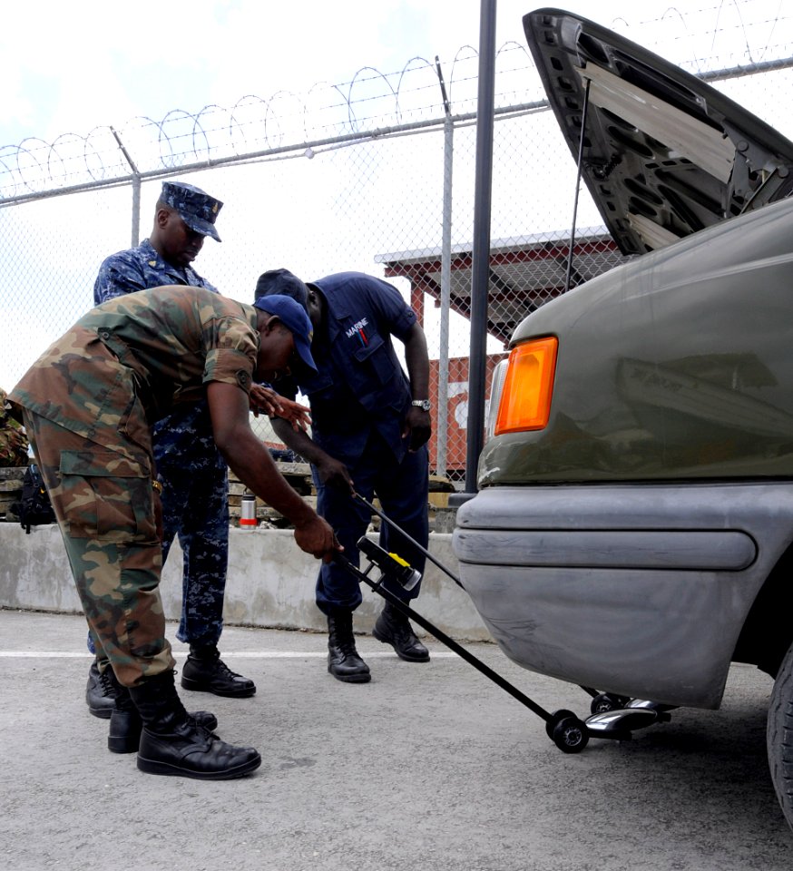 US Navy 100819-N-9643W-145 Senior Chief Master-at-Arms Charles Mobley instructs members of the Barbados Defense Force during a vehicle search drill during a Navy Criminal Investigative Service subject matter exchange for Southe