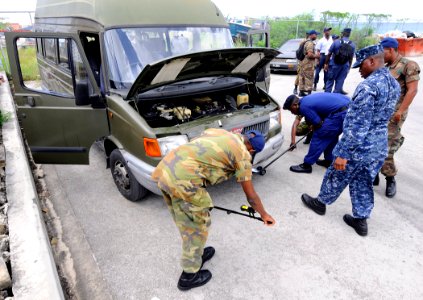 US Navy 100819-N-9643W-414 enior Chief Master-at-Arms Charles Mobley instructs members of the Barbados Defense Force during a vehicle search drill during a Navy Criminal Investigative Service subject matter exchange for Souther