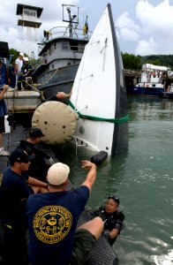 US Navy 100819-N-9769P-291 Sailors assigned to Company 2-6 of Mobile Diving and Salvage Unit (MDSU) 2, and teams from partner nations Panama, Columbia and Peru used lift bags to bring a boat to the surface