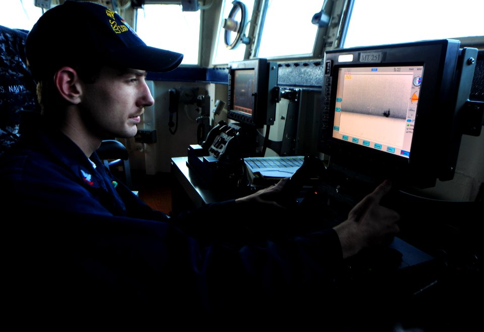 US Navy 100820-N-7948R-018 Gunner's Mate 2nd Class Taylor Steichen remotely observes a vessel aboard USS Pearl Harbor (LSD 52)