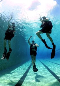US Navy 100817-N-9769P-069 Navy Diver 2nd Class David Orme, center, and Colombian divers, Capt. Camilo Cifuentez, right, and Chief Technician Aurelio Alonso, slowly ascend to the surface during underwater gear familiarization