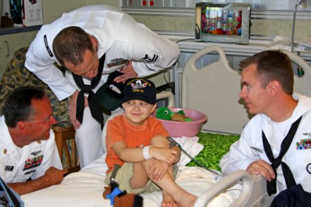 US Navy 100820-N-3038C-109 Command Master Chief Dave Bisson and area Sailors present a Navy ball cap to a patient at St. Luke's Children's Hospital during Boise Navy Week