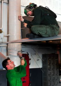 US Navy 100818-N-5838W-011 Sailors fasten rivets into the wing of an EA-6B Prowler